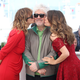 Director Pedro Almodovar getting smooched by actresses Emma Suarez and Adriana Ugarte at Cannes last year / Image via Getty